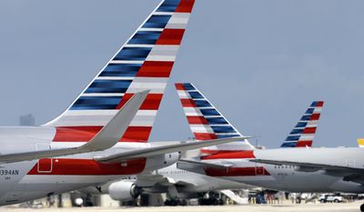 FILE - In this May 27, 2015, file photo, American Airlines jets taxi at Miami International Airport, in Miami. On Wednesday, Aug. 2, 2017, Qatar Airways said it is dropping an attempt to buy a big stake in American Airlines, an audacious bid that had received a chilly reception from American. (AP Photo/Lynne Sladky, File)