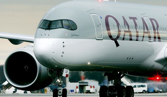 FILE- In this Jan. 15, 2015, file photo, a Qatar Airways jet arriving from Doha, Qatar, approaches the gate at the airport in Frankfurt, Germany. On Wednesday, Aug. 2, 2017, Qatar Airways said it is dropping an attempt to buy a big stake in American Airlines, an audacious bid that had received a chilly reception from American. (AP Photo/Michael Probst, File)