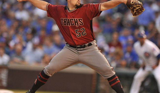 Arizona Diamondbacks starter Zack Godley delivers a pitch during the first inning of a baseball game against the Chicago Cubs Wednesday, Aug. 2, 2017, in Chicago. (AP Photo/Paul Beaty)