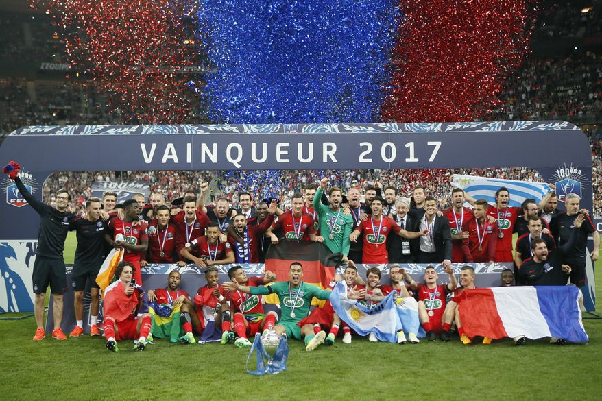 FILE - In this May 27, 2017 file photo, the Paris Saint-Germain's team celebrate with their trophy after winning the French Cup 2017 Final soccer match, between Paris Saint-Germain (PSG) and Angers at Stade de France in Saint Denis, north of Paris, France. PSG is aiming to win the league title this season after finishing behind Monaco in the last campaign. (AP Photo/Francois Mori, File)