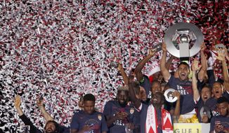 FILE - In this May 17, 2017 file photo, Monaco players hold the trophy as they celebrate their French League One title after beating Saint Etienne during the League One soccer match Monaco against Saint Etienne, at the Louis II stadium in Monaco. Monaco has made a lot of money this summer on the transfer market, and the French league champions’ bank accounts could look even better in a few weeks if Kylian Mbappe leaves for Real Madrid. (AP Photo/Claude Paris, File)