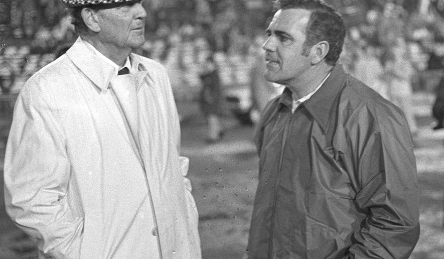 FILE - In this Dec. 31, 1973, file photo, Alabama coach Paul "Bear" Bryant, left, talks with Notre Dame coach Ara Parseghian prior to the Sugar Bowl college football game, in New Orleans, La. Parseghian, who took over a foundering Notre Dame football program and restored it to glory with two national championships in 11 seasons, died Wednesday, Aug. 2, 2017, at his home in Granger, Ind. He was 94. (AP Photo/Joe Raymond/File)