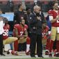 FILE - In this Nov. 20, 2016, file photo, San Francisco 49ers quarterback Colin Kaepernick (7) kneels next to outside linebacker Eli Harold (58) and safety Eric Reid, right rear, during the national anthem before an NFL football game against the New England Patriots in Santa Clara, Calif. It’s been a week since Baltimore Ravens coach John Harbaugh floated the idea of adding Kaepernick, a veteran who has Super Bowl experience and the baggage that comes from his decision last year to literally sit out the National Anthem on game day. (AP Photo/Marcio Jose Sanchez, File)