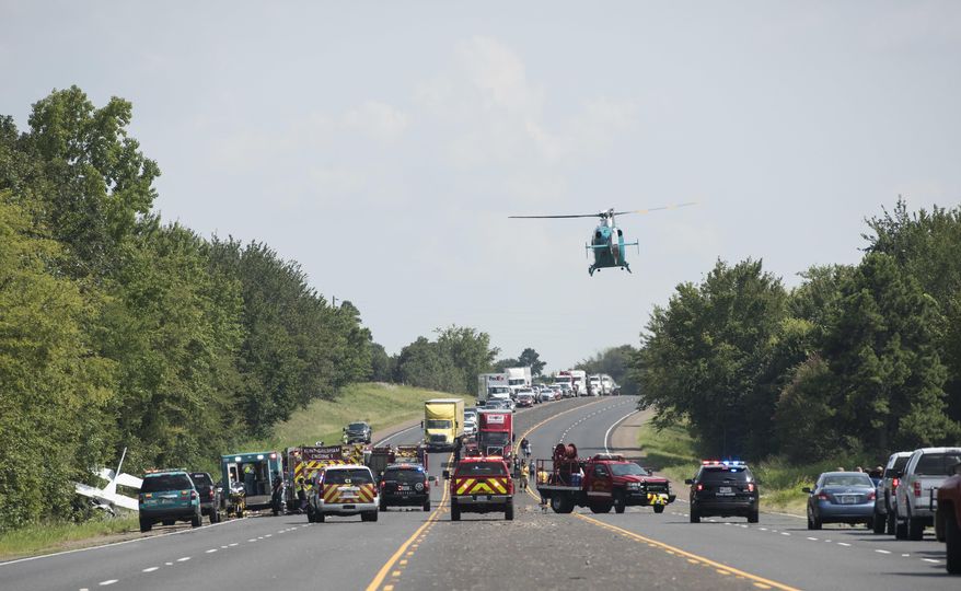 A medical helicopter leaves the scene of a downed aircraft, seen off the shoulder of U.S. Highway 69, north of Mount Selman, Texas, Tuesday, Aug. 1, 2017. The small engine plane had two occupants. Injuries are unknown at this time, according to an email from The Texas Department of Public Safety. (Sarah A. Miller/Tyler Morning Telegraph via AP)