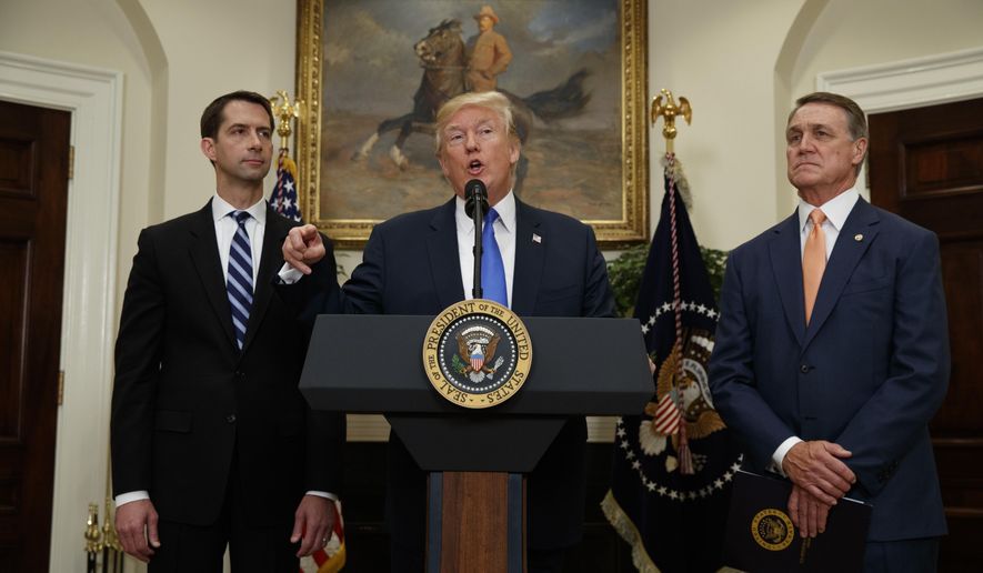 President Donald Trump, flanked by Sen. Tom Cotton, R- Ark., left, and Sen. David Perdue, R-Ga., speaks in the Roosevelt Room of the White House in Washington, Wednesday, Aug. 2, 2017, during the unveiling of legislation that would place new limits on legal immigration. (AP Photo/Evan Vucci)