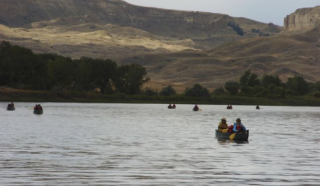 FILE - In this Sept. 19, 2011 file photo, a group canoes through the Upper Missouri River Breaks National Monument near Fort Benton, Mont. Interior Secretary Ryan Zinke says he will not recommend changes to Montana&#x27;s Upper Missouri River Breaks National Monument as he continues to review national monuments for possible elimination or reduction.  (AP Photo/Matthew Brown, File)