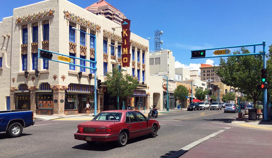 FILE - In this Aug. 1, 2016 file photo, traffic moves past the Kimo Theater along historic Route 66 in downtown Albuquerque, N.M. Attorney General Jeff Sessions is cracking down on so-called sanctuary cities, threatening to keep federal crime-fighting resources from cities ravaged by violence if they don't cooperate with federal immigration authorities. The Justice Department sent letters to Baltimore, Albuquerque, and Stockton and San Bernardino, Calif., telling them they will be ineligible for a new program if they don't step up efforts to help detain and deport those in the country illegally. (AP Photo/Russell Contreras, File)