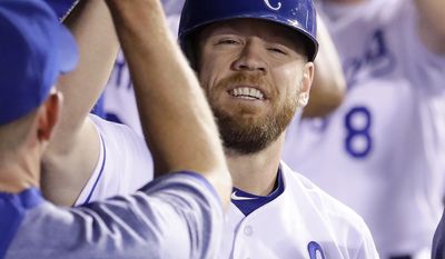 Kansas City Royals' Brandon Moss celebrates in the dugout after hitting a two-run home run during the fifth inning of a baseball game against the Seattle Mariners Thursday, Aug. 3, 2017, in Kansas City, Mo. (AP Photo/Charlie Riedel)