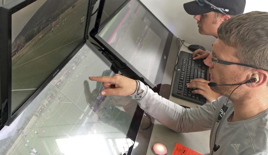 In this July 11, 2017, still image from video, MLS referee Dave Gantar watches a replay during a video replay scrimmage organized in a community park, in Park City, Utah. Games were staged as part of the final training camp to gauge MLS referees' competence in and comfort with video replay. (AP Photo/Rick Bowmer)