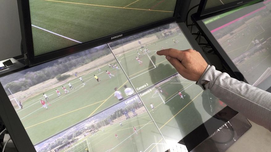 In this July 11, 2017, still image from video, MLS referee Dave Gantar points at the screen during a video replay scrimmage organized in a community park, in Park City, Utah. Games were staged as part of the final training camp to gauge MLS referees' competence in and comfort with video replay. (AP Photo/Rick Bowmer)