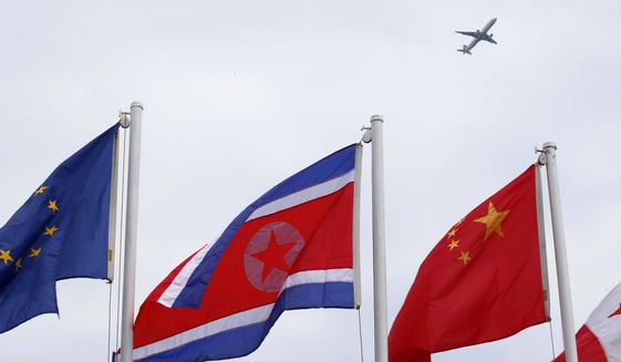 A North Korean flag flies with other flags of the ASEAN countries and its dialogue partners outside the Philippine International Convention Center, the venue for the Aug. 2-8, 2017 50th ASEAN Foreign Ministers&#39; Meeting, as a passenger plane flies above Thursday, Aug. 3, 2017 in Manila, Philippines. (AP Photo/Bullit Marquez)