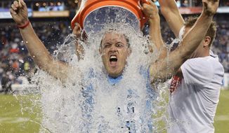 FILE - In this Aug. 28, 2014, file photo, former Tennessee Titans linebacker Tim Shaw is doused as he takes the ALS Ice Bucket Challenge during a preseason NFL football game between the Titans and the Minnesota Vikings in Nashville, Tenn. To the Tennessee Titans, Tim Shaw is a teammate for life, and the former special teams captain even has his own locker even as he battles ALS, amyotrophic lateral sclerosis better known as Lou Gehrig&#39;s disease. (AP Photo/Mark Zaleski, File)