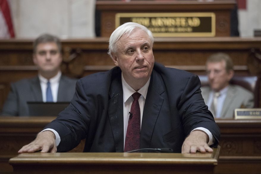 FILE - In this Jan. 8, 2017 file photo, West Virginia Gov. Jim Justice delivers his first State of the State speech in Charleston, W.Va. Justice is switching parties to join Republicans as President Donald Trump plans a visit to the increasingly conservative state. (AP Photo/Walter Scriptunas II, File)
