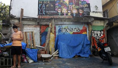In this May 26, 2017, photo is an entrance into the Indiana slum, where several houses were demolished in the lead-up to the Olympics, in Rio de Janeiro, Brazil. Despite being more than three miles away from the closest Olympic venue, the northern community of Indiana was also targeted for eviction. More than 70,000 people were displaced to make way for last year’s Rio de Janeiro’s Olympics. (AP Photo/Liliana Michelena)
