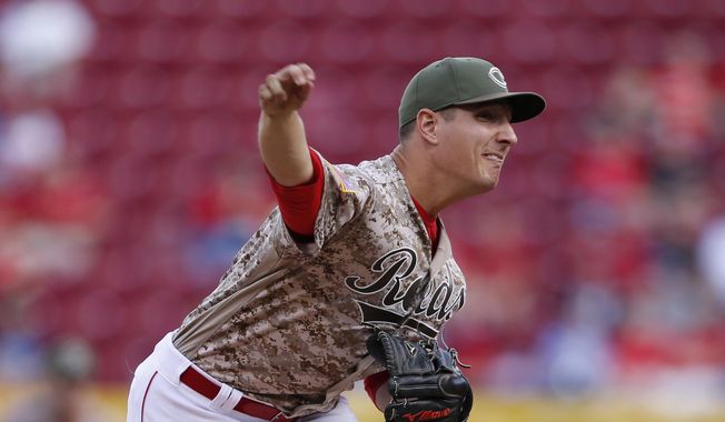 Cincinnati Reds starting pitcher Asher Wojciechowski throws against the St. Louis Cardinals during the first inning of a baseball game, Friday, Aug. 4, 2017, in Cincinnati. (AP Photo/Gary Landers)