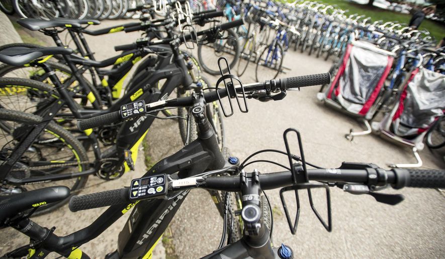 ADVANCE FOR USE SATURDAY, AUG 5 - In this Wednesday, July 26, 2017, photo, about 25 e-bikes in the rental fleet of Aspen Velo and a similar number of other bicycles sit on display for sale outside the shop in Aspen, Colo. For aging or injured cyclists with diminished ability to ride, e-bikes offer a new way to pursue the sport. (Anna Stonehouse/The Aspen Times via AP)