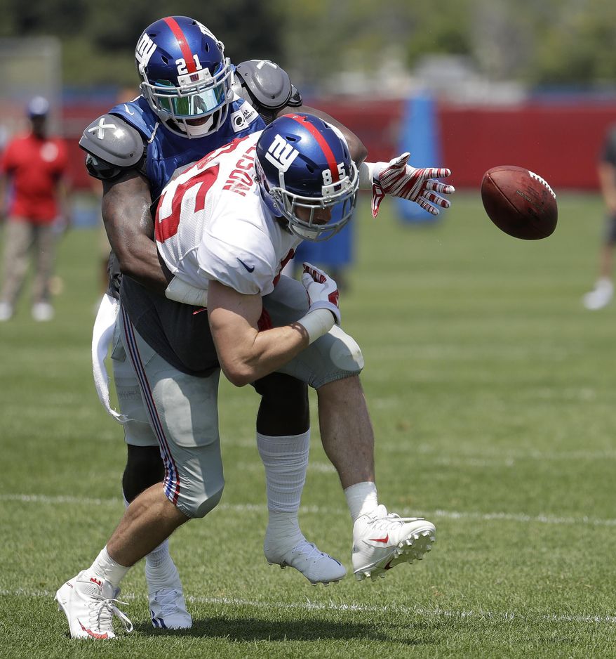 New York Giants strong safety Landon Collins, back, applies a hard hit causing tight end Rhett Ellison to fumble during NFL football training camp, Thursday, Aug. 3, 2017, in East Rutherford, N.J. (AP Photo/Julio Cortez)