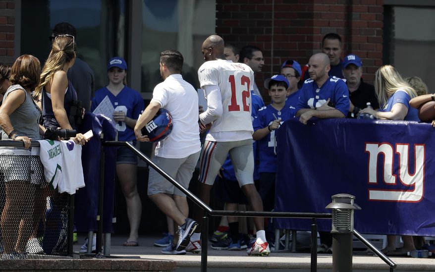 Spectators look on as New York Giants wide receiver Tavarres King (12) leaves the field early after limping off a play during NFL football training camp, Thursday, Aug. 3, 2017, in East Rutherford, N.J. (AP Photo/Julio Cortez)