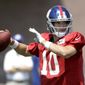 New York Giants quarterback Eli Manning throws a pass during NFL football training camp, Thursday, Aug. 3, 2017, in East Rutherford, N.J. (AP Photo/Julio Cortez)