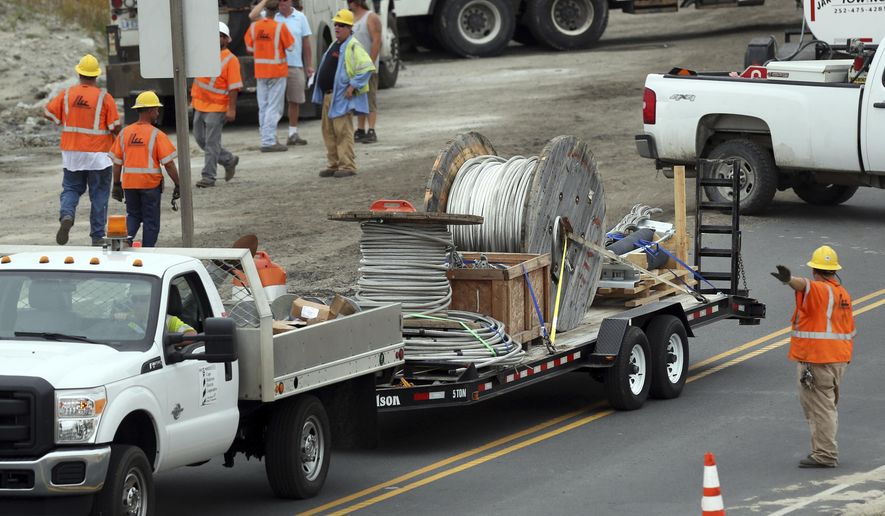 Materials are brought in to restore power to Hatteras Island, Thursday, Aug. 3, 2017, in Rodanthe, N.C. Workers building the replacement Bonner Bridge over the Oregon Inlet accidentally severed two underground power lines on July 27. Utility officials say they expect to restore power to two North Carolina islands by the weekend. (Steve Earley/The Virginian-Pilot via AP)