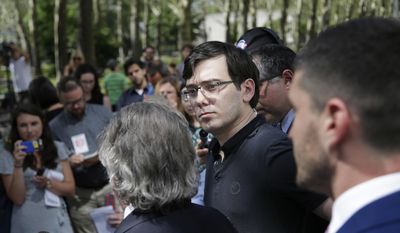 Martin Shkreli stands with his attorneys as they talk to reporters in front of federal court in New York, Friday, Aug. 4, 2017. The former pharmaceutical CEO has been convicted on federal charges he deceived investors in a pair of failed hedge funds. A Brooklyn jury deliberated five days before finding Shkreli guilty on Friday on three of eight counts. (AP Photo/Seth Wenig)