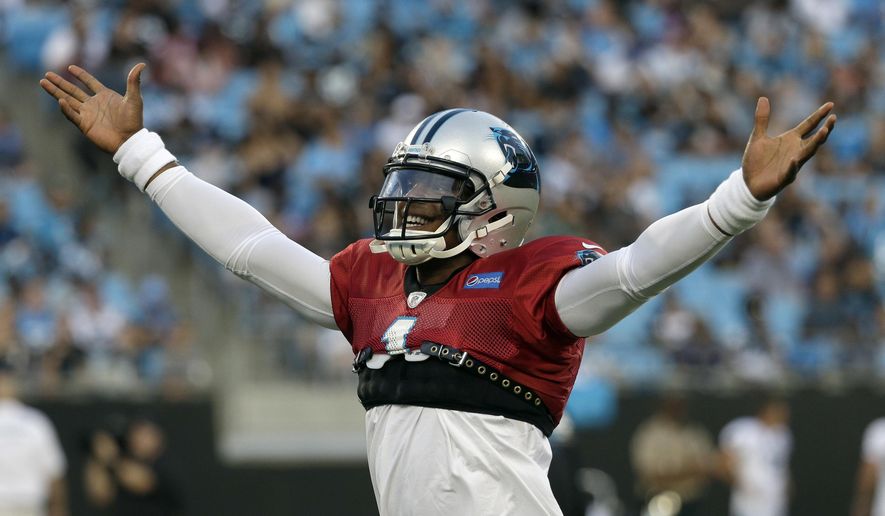 Carolina Panthers' Cam Newton (1) plays to the crowd during practice at the NFL football team's Fan Fest in Charlotte, N.C., Friday, Aug. 4, 2017. (AP Photo/Chuck Burton)