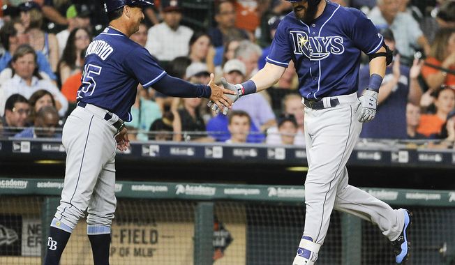 Tampa Bay Rays&#x27; Steven Souza Jr., right, shakes hands with third base coach Charlie Montoyo after hitting a solo home run off Houston Astros starting pitcher Collin McHugh during the sixth inning of a baseball game, Thursday, Aug. 3, 2017, in Houston. (AP Photo/Eric Christian Smith)