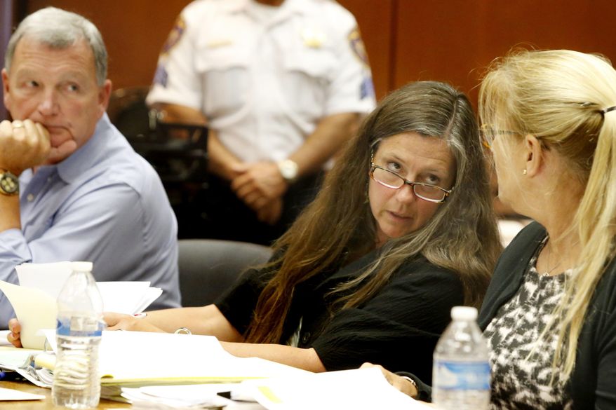 Scott Phillips, left, looks on as his wife Theresa Mullen, center, talk to their attorney Susan Brandt McCrea during the trial on Thursday, Aug. 3, 2017 in Newark. The parents of Sydney Phillips and her younger sister, Kaitlyn are seeking a court order to allow the girls to return to their Catholic school in Kenilworth after a dispute over one of them wanting to play on the boys basketball team. (Aristide Economopoulos/NJ Advance Media via AP, Pool)