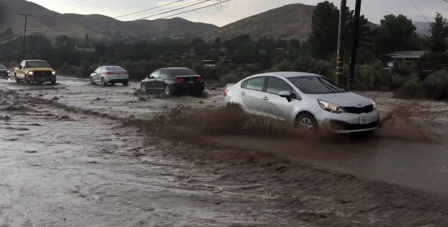 This video image courtesy of Andy Villalobos shows flooding in Acton, Calif. Moist, monsoonal air is causing storms and forecasters say they could dump up to an inch of rain per hour. The National Weather Service has issued flood watches for the mountains and the Antelope Valley through the evening. (Andy Villalobos via AP)