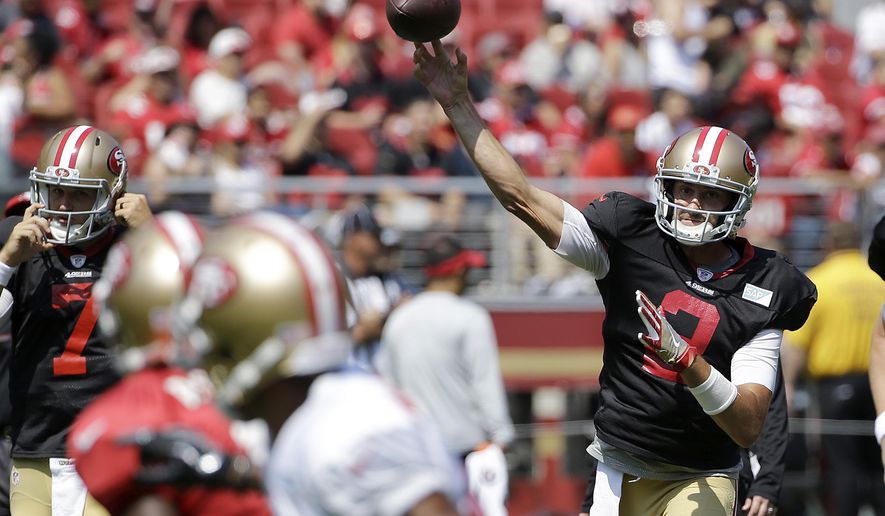 San Francisco 49ers' Brian Hoyer, right, throws a pass during an NFL football training camp in Santa Clara, Calif., Saturday, Aug. 5, 2017. (AP Photo/Jeff Chiu)
