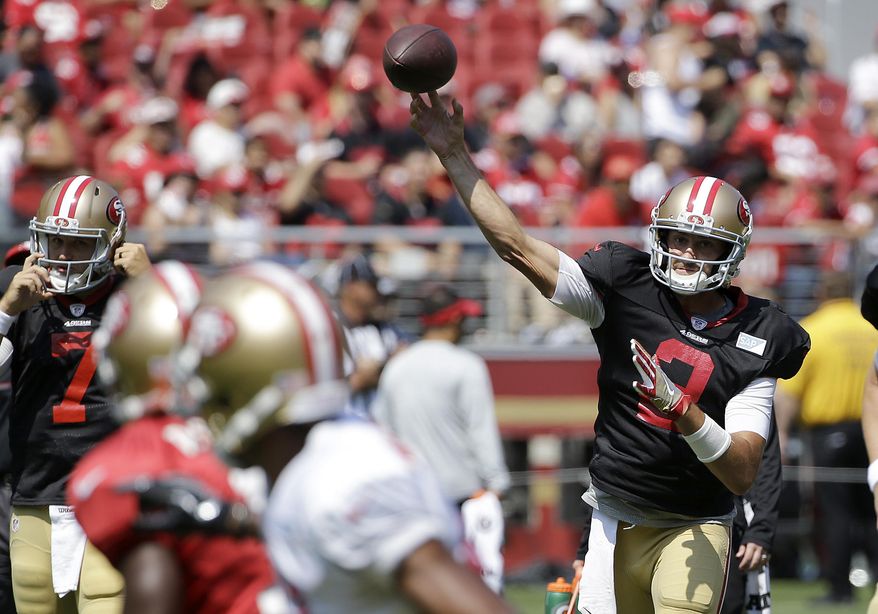 San Francisco 49ers' Brian Hoyer, right, throws a pass during an NFL football training camp in Santa Clara, Calif., Saturday, Aug. 5, 2017. (AP Photo/Jeff Chiu)