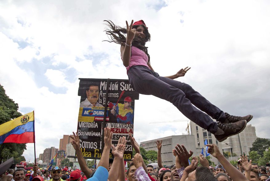 A supporter of Venezuela&#x27;s President Nicolas Maduro is tossed into the air before the start of a march to the National Assembly for the swearing-in ceremony of the Constitutional Assembly, in Caracas, Venezuela, Friday, Aug. 4, 2017. Venezuelan President Nicolas Maduro is heading toward a showdown with his political foes, preparing to seat a loyalist assembly that will rewrite the country&#x27;s constitution and hold powers that override all other government branches. (AP Photo/Wil Riera)