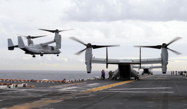 In this June 29, 2017, file photo U.S. Marine MV-22B Osprey aircraft land on the deck of the USS Bonhomme Richard amphibious assault ship off the coast from Sydney during events marking the start of Talisman Saber 2017, a biennial joint military exercise between the United States and Australia. A MV-22 Osprey that had launched from the USS Bonhomme was conducting regularly scheduled operations when it crashed into the water off Australia&#x27;s east coast, Saturday, Aug. 5. (Jason Reed/Pool Photo via AP, File)