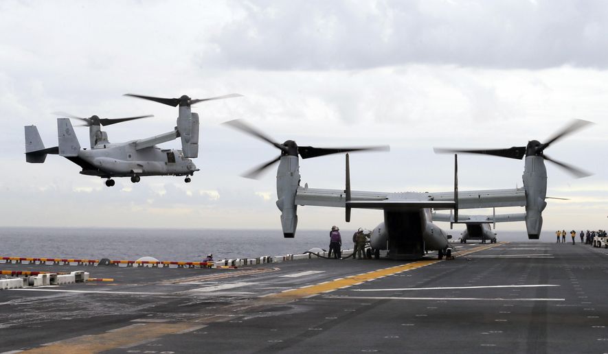 In this June 29, 2017, file photo U.S. Marine MV-22B Osprey aircraft land on the deck of the USS Bonhomme Richard amphibious assault ship off the coast from Sydney during events marking the start of Talisman Saber 2017, a biennial joint military exercise between the United States and Australia. A MV-22 Osprey that had launched from the USS Bonhomme was conducting regularly scheduled operations when it crashed into the water off Australia&#39;s east coast, Saturday, Aug. 5. (Jason Reed/Pool Photo via AP, File)