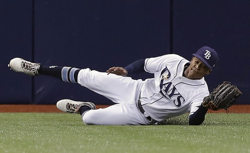 Tampa Bay Rays center fielder Mallex Smith slides across the turf after making a catch on a fly-out by Milwaukee Brewers&#39; Domingo Santana during the first inning of a baseball game Saturday, Aug. 5, 2017, in St. Petersburg, Fla. (AP Photo/Chris O&#39;Meara)
