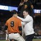 San Francisco Giants&#39; Brandon Belt (9) is tended to by manager Bruce Bochy, top, and trainer Dave Groeschner after being hit by a pitch during the sixth inning of the team&#39;s baseball game against the Arizona Diamondback in San Francisco, Friday, Aug. 4, 2017. (AP Photo/Jeff Chiu)