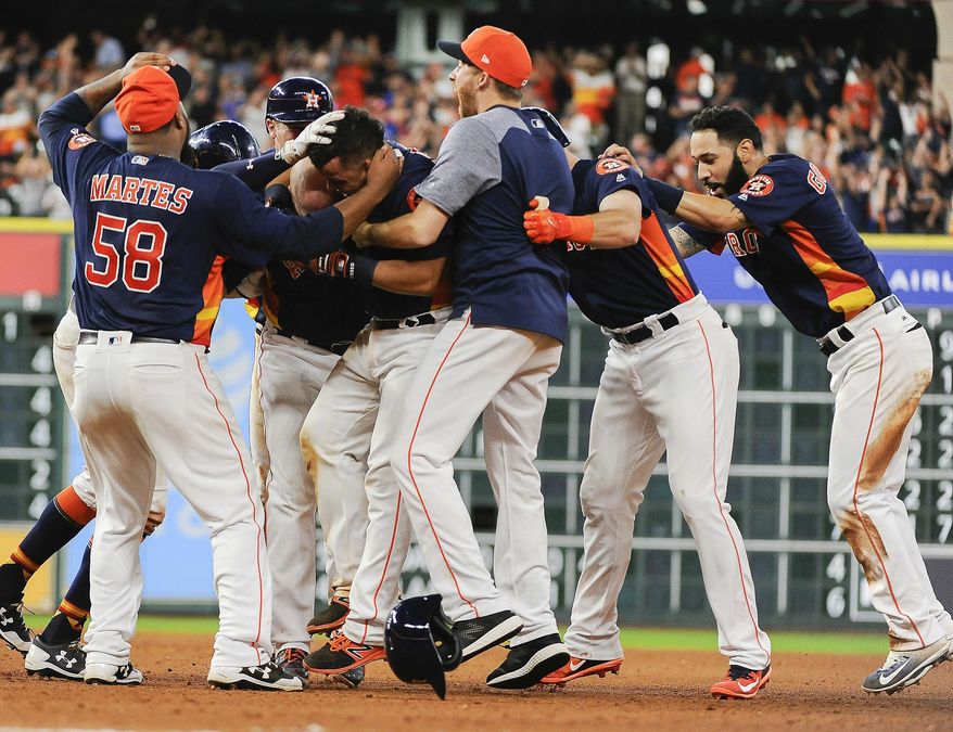 Houston Astros' Juan Centeno, second from left, is mobbed by teammates after his walkoff RBI-single in a baseball game against the Toronto Blue Jays, Sunday, Aug. 6, 2017, in Houston. (AP Photo/Eric Christian Smith)