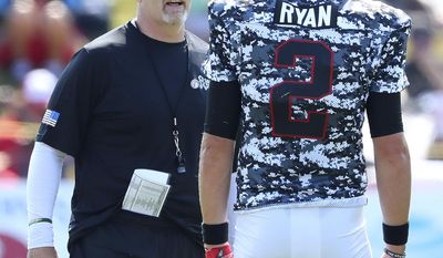 Atlanta Falcons head coach Dan Quinn confers with quarterback Matt Ryan during Military Day at team practice on Sunday, Aug. 6, 2017, in Flowery Branch Ga. (Curtis Compton/Atlanta Journal-Constitution via AP)
