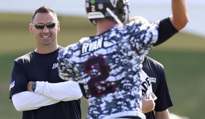 Atlanta Falcons offensive coordinator Steve Sarkisian looks on while quarterback Matt Ryan throws a pass at team football practice during Military Day on Sunday, Aug. 6, 2017, in Flowery Branch, Ga. (Curtis Compton/Atlanta Journal-Constitution via AP)