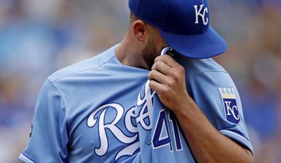Kansas City Royals starting pitcher Danny Duffy wipes away sweat during the first inning of the first baseball game of a doubleheader against the Seattle Mariners Sunday, Aug. 6, 2017, in Kansas City, Mo. (AP Photo/Charlie Riedel)