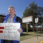 In this Feb. 24, 2016 photo, Randy Gamel is photographed at Maudrie M. Walton Elementary in Fort Worth, Texas. Gamel, a retiree who moved with his husband to a tiny western Oklahoma town alleges he was routinely harassed by townspeople, but was ignored by law enforcement until his home was burned. Gamel acknowledges that before moving to Oklahoma, his criticism of staff and teachers at his son&#39;s Fort Worth elementary school became so heated that district officials prohibited him last year from visiting the school. He filed a lawsuit Thursday, Aug. 3, 2017, that suggests he was targeted in part because he and his partner brought a black child into the nearly all-white town of Hitchcock, Okla. (Khampha Bouaphanh/Star-Telegram via AP)