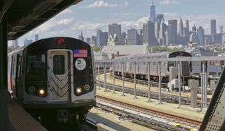 In this June 21, 2017 file photo, a subway train approaches the platform at Brooklyn&#x27;s Smith Street above-ground subway station, in New York. (AP Photo/Bebeto Matthews, File)