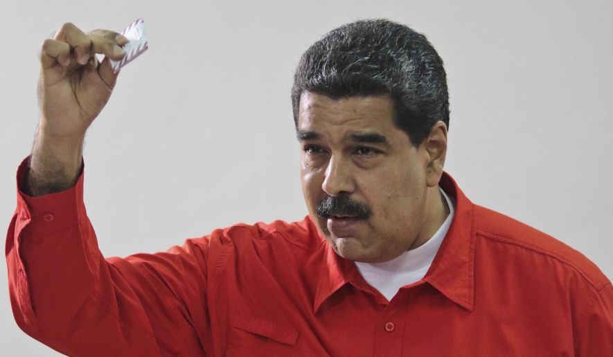 Venezuela&#39;s President Nicolas Maduro shows his ballot after casting a vote for a constitutional assembly in Caracas, Venezuela, July 30. (Miraflores Press Office via AP) ** FILE **