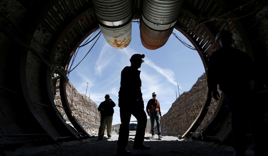 In this April 9, 2015, file photo, people walk into the south portal of Yucca Mountain during a congressional tour of the proposed radioactive waste dump near Mercury, Nev., 90 miles northwest of Las Vegas. (AP Photo/John Locher, File)