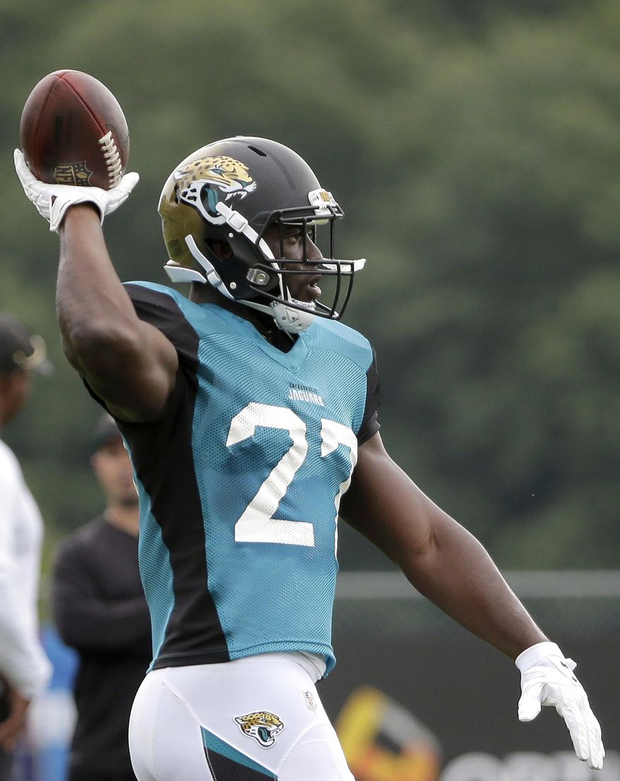 Jacksonville Jaguars running back Leonard Fournette throws the ball during an NFL football joint practice with the New England Patriots, Monday, Aug. 7, 2017, in Foxborough, Mass. (AP Photo/Steven Senne)