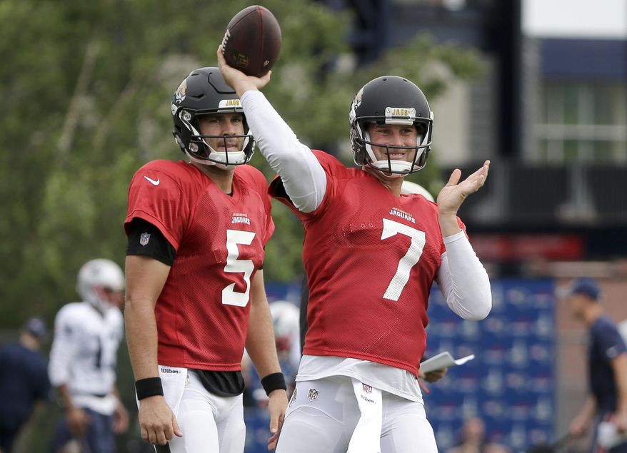 Jacksonville Jaguars quarterback Chad Henne, right, passes the ball as quarterback Blake Bortles, left, looks on during an NFL football joint practice with the New England Patriots, Monday, Aug. 7, 2017, in Foxborough, Mass. (AP Photo/Steven Senne)
