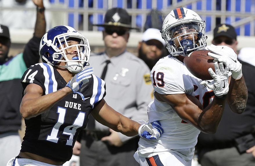 FILe - In this Oct. 1, 2016, file photo, Duke's Bryon Fields (14) defends as Virginia's Andre Levrone (19) catches a pass during the second half of an NCAA college football game in Durham, N.C. Levrone made a big impression on Virginia coach Bronco Mendenhall last year in spring practice. This year, the senior wide receiver hopes to carry that over onto the field. (AP Photo/Gerry Broome, File)