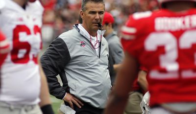 FILE - In this April 15, 2017, file photo, Ohio State head coach Urban Meyer watches from behind the line of scrimmage during their NCAA college spring football game in Columbus, Ohio. Meyer said he thought last season’s team made it to the playoffs a year ahead of schedule. With Barrett running the offense and one of the best defenses in the nation, Ohio State expects nothing less than to be in the playoffs for the third time in four seasons.(AP Photo/Jay LaPrete)