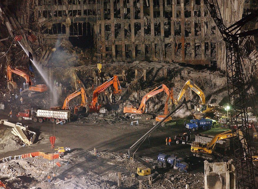 FILE - In this Nov. 7, 2001 file photo, workers and heavy machinery continue the cleanup and recovery effort in front of the remaining facade of 1 World Trade Center at ground zero in New York.The remains of a man killed at the World Trade Center on 9/11 have been identified for the first time nearly 16 years after the terror attacks, the New York City medical examiners' office announced Monday Aug.7, 2017. Medical examiners use DNA testing and other means to try to match bone fragments to the 2,753 people killed by the hijackers who crashed airplanes into the trade center's twin towers on Sept. 11, 2001. Remains of 1,641 victims have been identified so far.(AP Photo/Stephen Chernin, File)
