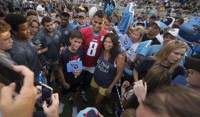 Tennessee Titans quarterback Marcus Mariota (8) poses for pictures before practice at NFL football training camp, at Centennial High School on Friday, Aug. 4, 2017 in Franklin, Tenn. (George Walker IV//The Tennessean via AP)